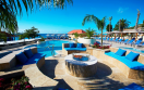 DIVI LITTLE BAY BEACH RESORT PURE OCEAN POOL LOUNGING CHAIRS FIREPIT 